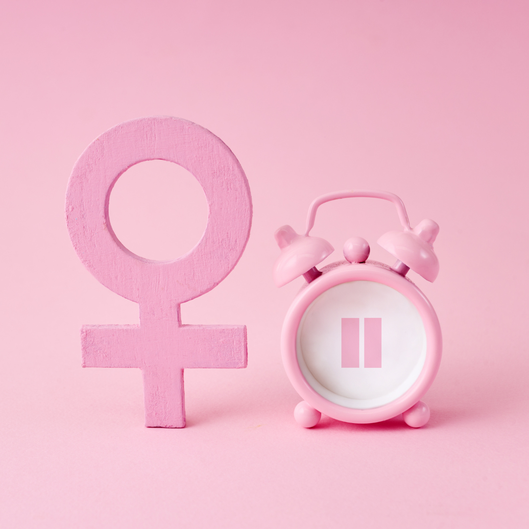 Female symbol beside a pink alarm clock
